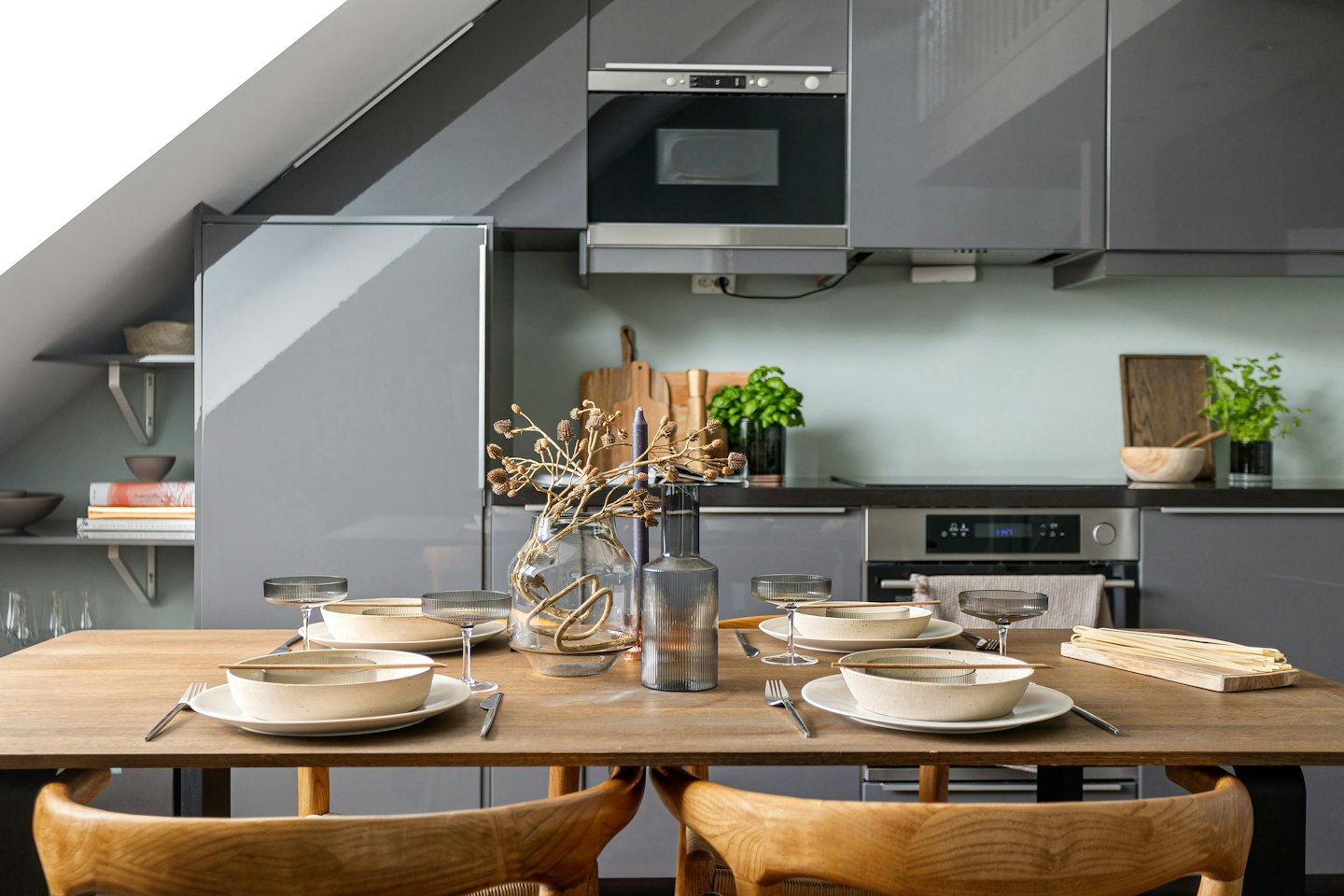Table set for four in a modern kitchen with grey cabinets.